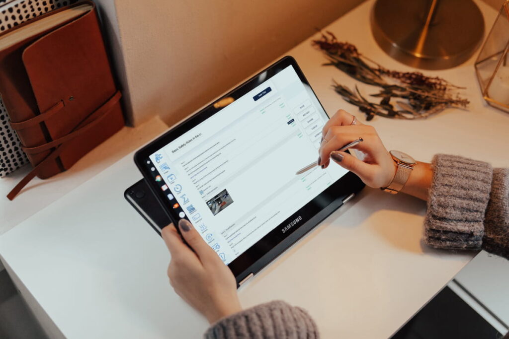 A woman checking laboratory documentation in Digital GxP, a Laboratory Information Management System (LIMS) on a tablet.