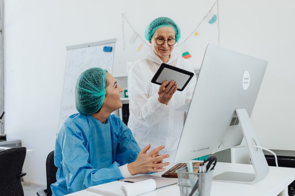 Scientist Looking at Lab Notes on Tablet and Monitor. Electronic Laboratory Notebook (ELN)